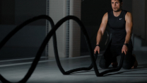 woman in black tank top and black pants sitting on black exercise equipment